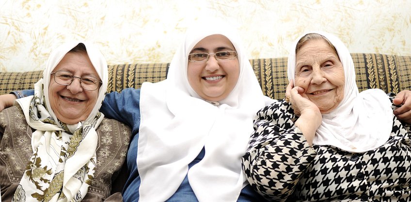 Three women sitting and smiling