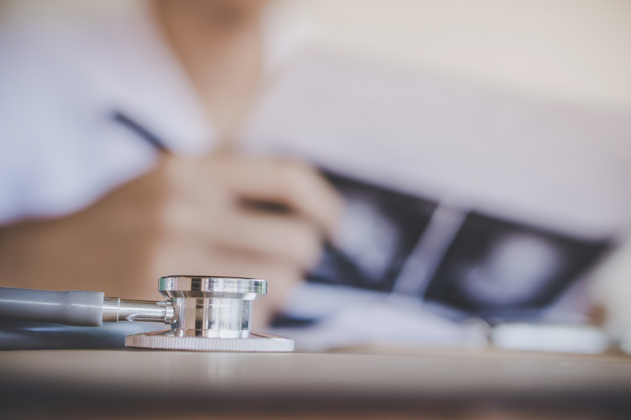 doctor working in office analyzing x-ray medical picture