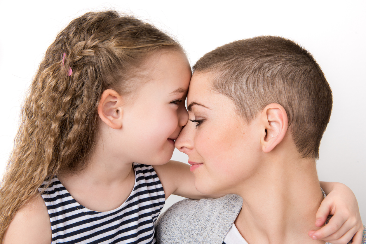 Daughter hugging cancer survivor mother helping with breast cancer depression