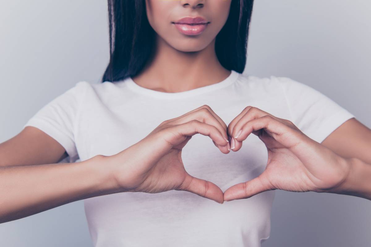 Woman making breast health symbol with her hands